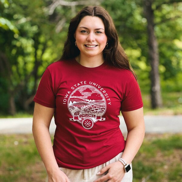 A student wearing Uscape I-State Cardinal Crest Lightweight Short Sleeve T-Shirt
